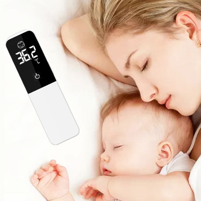 A mother and her baby sleeping peacefully beside a MediWares digital thermometer displaying a temperature, suggesting the measurement of room temperature for comfort.