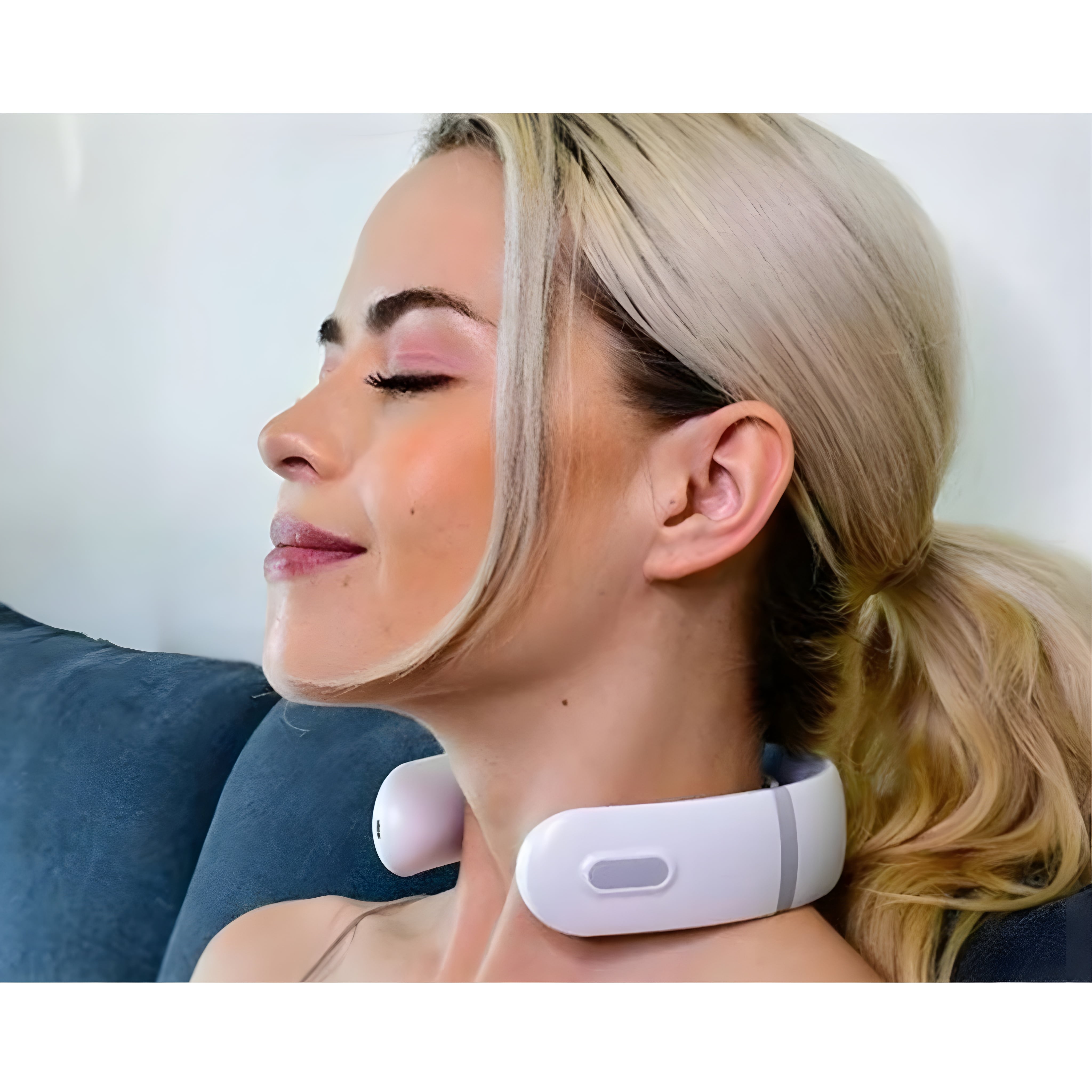Woman relaxing on couch wearing the neck massager with eyes closed in comfort